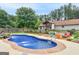 Picture-perfect backyard features a swimming pool and beautiful, mature landscaping at 552 New Hope Rd, Mcdonough, GA 30252
