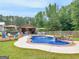 Backyard with an in-ground pool, hot tub, waterfall, and outdoor kitchen perfect for entertaining at 552 New Hope Rd, Mcdonough, GA 30252