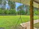 View of the expansive, fenced backyard from the covered porch, showcasing the lush greenery and privacy at 552 New Hope Rd, Mcdonough, GA 30252