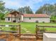 Exterior view of backyard with a wooden fence, lush lawn, and patio with seating area at 552 New Hope Rd, Mcdonough, GA 30252