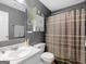 Bathroom with gray walls, neutral shower curtain, toilet, and vanity at 552 New Hope Rd, Mcdonough, GA 30252
