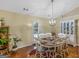 Cozy dining room featuring a round table with seating for six and natural light from the glass-paneled door at 552 New Hope Rd, Mcdonough, GA 30252