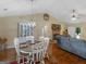 Open dining room featuring vaulted ceiling, wood floors, a decorative chandelier and an adjacent Gathering room at 552 New Hope Rd, Mcdonough, GA 30252