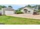 Home's exterior featuring a large driveway, detached garage, and well-maintained lawn at 552 New Hope Rd, Mcdonough, GA 30252