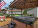 Relax in style with this hot tub, complemented by a stone patio and lush backyard views at 552 New Hope Rd, Mcdonough, GA 30252
