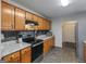 Well-lit kitchen with wood cabinets, sleek countertops and a suite of stainless steel appliances for a modern touch at 552 New Hope Rd, Mcdonough, GA 30252