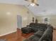 Spacious living room featuring a large sectional sofa, vaulted ceiling, ceiling fan, and hardwood floors at 552 New Hope Rd, Mcdonough, GA 30252