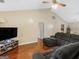 Comfortable living room with modern entertainment center, ceiling fan, and plenty of natural light at 552 New Hope Rd, Mcdonough, GA 30252