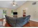 Bright living room with hardwood floors and a sectional sofa, offering a glimpse into the Primary bedroom at 552 New Hope Rd, Mcdonough, GA 30252