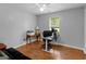 Bright office space featuring a desk, hardwood floors, and natural light from the window at 552 New Hope Rd, Mcdonough, GA 30252