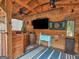 Entertain in this wood-finished outdoor bar, complete with dartboard, TV, cooler, and rustic decor at 552 New Hope Rd, Mcdonough, GA 30252