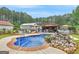 Inviting backyard with a pool and lush landscaping creates a serene outdoor escape at 552 New Hope Rd, Mcdonough, GA 30252