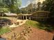 Expansive backyard with a fire pit, lush greenery, and a patio ideal for outdoor activities and relaxation at 2062 Valiant Ne Dr, Atlanta, GA 30345