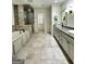 Luxury bathroom with dual sinks, granite countertops, custom cabinets, and separate tub and shower at 2062 Valiant Ne Dr, Atlanta, GA 30345
