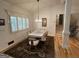 Bright dining room featuring white trim, hardwood floors and modern chandelier at 2062 Valiant Ne Dr, Atlanta, GA 30345