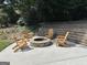 A cozy stone fire pit surrounded by wooden Adirondack chairs for relaxing and outdoor gatherings at 2062 Valiant Ne Dr, Atlanta, GA 30345
