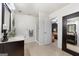 Bright bathroom with walk-in shower and large mirror reflecting a stylish design, creating a serene retreat at 312 Iron Horse Way, Stockbridge, GA 30281