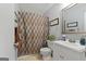 Cozy bathroom featuring a vanity with a decorative mirror and a shower with a patterned curtain at 312 Iron Horse Way, Stockbridge, GA 30281