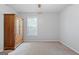 Neutral bedroom showing large wardrobe for storage, carpet flooring, and window at 312 Iron Horse Way, Stockbridge, GA 30281