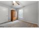 Bedroom with a ceiling fan, a large wardrobe for storage, carpet flooring, and natural light from a window at 312 Iron Horse Way, Stockbridge, GA 30281