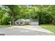 Single-story home with a large front yard, gray siding, and a driveway leading to an attached garage at 312 Iron Horse Way, Stockbridge, GA 30281