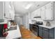 Modern kitchen with stainless steel appliances, bright white cabinets, and quartz countertops at 312 Iron Horse Way, Stockbridge, GA 30281