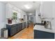 Well-lit kitchen with modern appliances, white cabinets, and a stainless-steel sink at 312 Iron Horse Way, Stockbridge, GA 30281