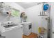 Functional laundry room with a washer, dryer, and water heater for convenient home maintenance at 312 Iron Horse Way, Stockbridge, GA 30281