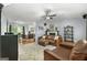 Open-concept living area with hardwood floors, a fireplace, and kitchen views at 312 Iron Horse Way, Stockbridge, GA 30281