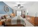 Spacious main bedroom with great natural light and an accent wall creates a cozy, relaxing atmosphere at 312 Iron Horse Way, Stockbridge, GA 30281