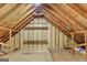 Unfinished attic with exposed wood beams, framing, and plywood subfloor at 1572 Hines Rd, Moreland, GA 30259