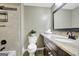 Bathroom featuring a granite countertop vanity, decorative mirror, and tiled shower at 1572 Hines Rd, Moreland, GA 30259