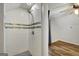 Stylish tiled shower with glass accents next to bedroom with fan and wood floors at 1572 Hines Rd, Moreland, GA 30259
