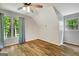 Bedroom with two windows, wood floors and neutral paint at 1572 Hines Rd, Moreland, GA 30259