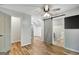 Open bedroom with wood floors, ceiling fan, sliding barn door and closet at 1572 Hines Rd, Moreland, GA 30259