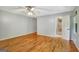 Bedroom with hardwood floors, neutral walls, and ensuite bathroom with tiled shower at 1572 Hines Rd, Moreland, GA 30259