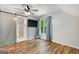 Bedroom with window and sliding barn door to bathroom; natural light and wood floors at 1572 Hines Rd, Moreland, GA 30259