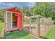 Exterior of chicken coop with nesting boxes and a covered outdoor run, offering a safe environment at 1572 Hines Rd, Moreland, GA 30259