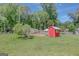 Backyard chicken coop and run in a well-maintained lawn, ready for your flock to enjoy the outdoors at 1572 Hines Rd, Moreland, GA 30259