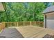 Spacious wooden deck offers an ideal outdoor living space and wooded views at 1572 Hines Rd, Moreland, GA 30259