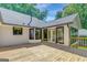 The rear of the home boasts a spacious wooden deck perfect for entertaining with lush surroundings at 1572 Hines Rd, Moreland, GA 30259