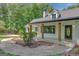 A charming house exterior featuring a front porch with wood columns, and a professionally landscaped front yard at 1572 Hines Rd, Moreland, GA 30259