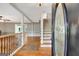 Inviting foyer entrance featuring hardwood floors, staircase, and an open layout with views of living areas at 1572 Hines Rd, Moreland, GA 30259