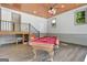 Spacious game room with a pool table, wood ceiling, and stairs to another room at 1572 Hines Rd, Moreland, GA 30259