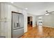 Bright kitchen with stainless steel refrigerator and adjacent living area, creating an open and inviting atmosphere at 1572 Hines Rd, Moreland, GA 30259