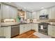 Stylish kitchen with stainless steel appliances, tile backsplash, granite countertops, and ample natural light at 1572 Hines Rd, Moreland, GA 30259