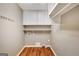 Bright laundry room with white cabinets and shelving at 1572 Hines Rd, Moreland, GA 30259