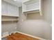 Efficient laundry room with white cabinets and shelving maximizes storage space at 1572 Hines Rd, Moreland, GA 30259