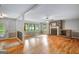 Spacious living room with hardwood floors, brick fireplace, ceiling fan, and large windows offering ample natural light at 1572 Hines Rd, Moreland, GA 30259