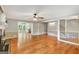 Bright living space with hardwood flooring, a cozy fireplace, and an open layout leading to other rooms at 1572 Hines Rd, Moreland, GA 30259